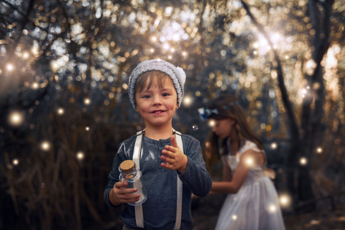 Children play with bubbles on their summer evening