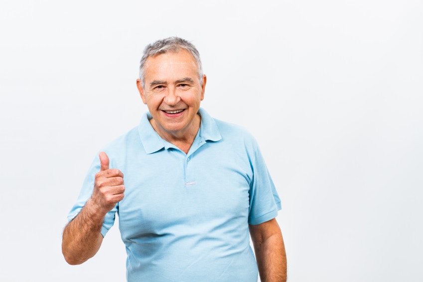 Happy senior man giving thumbs up