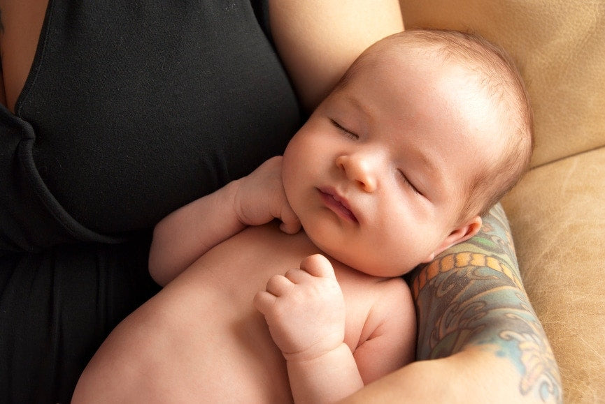 new born baby sleeping in mother's hand