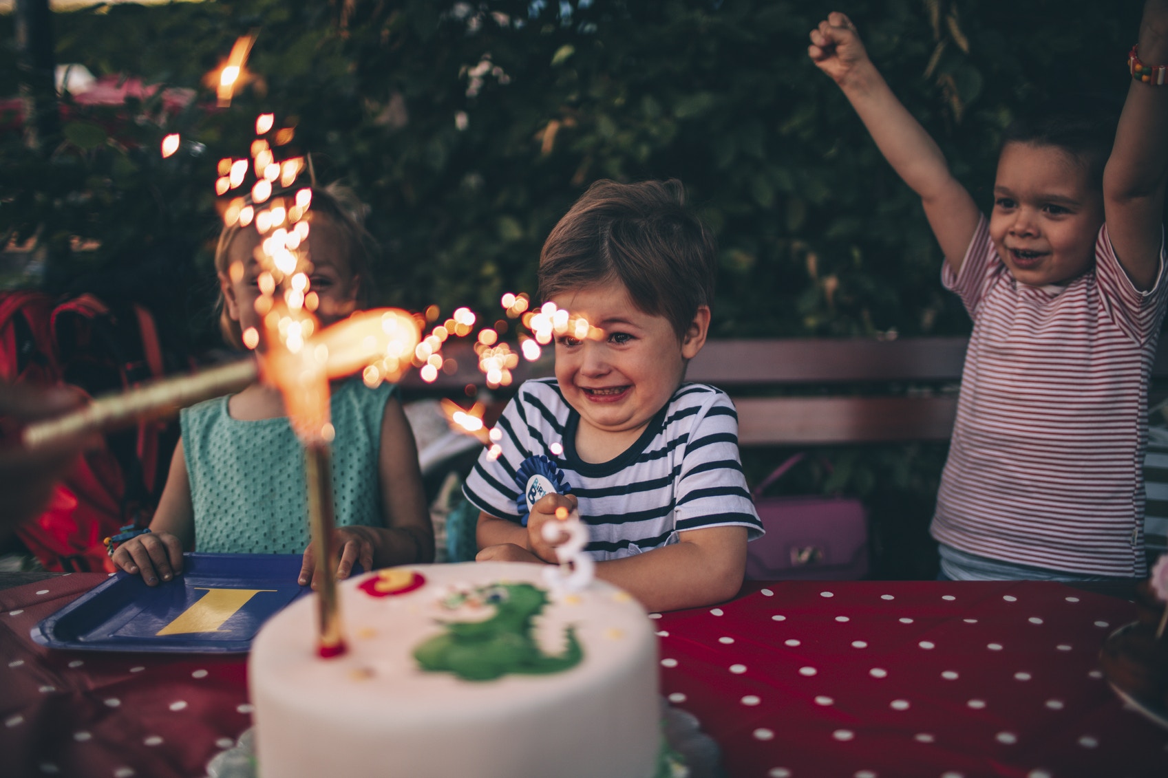 Excited young boy with birthday cake