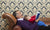 grandfather reading book for newborn grandson on  a sofa