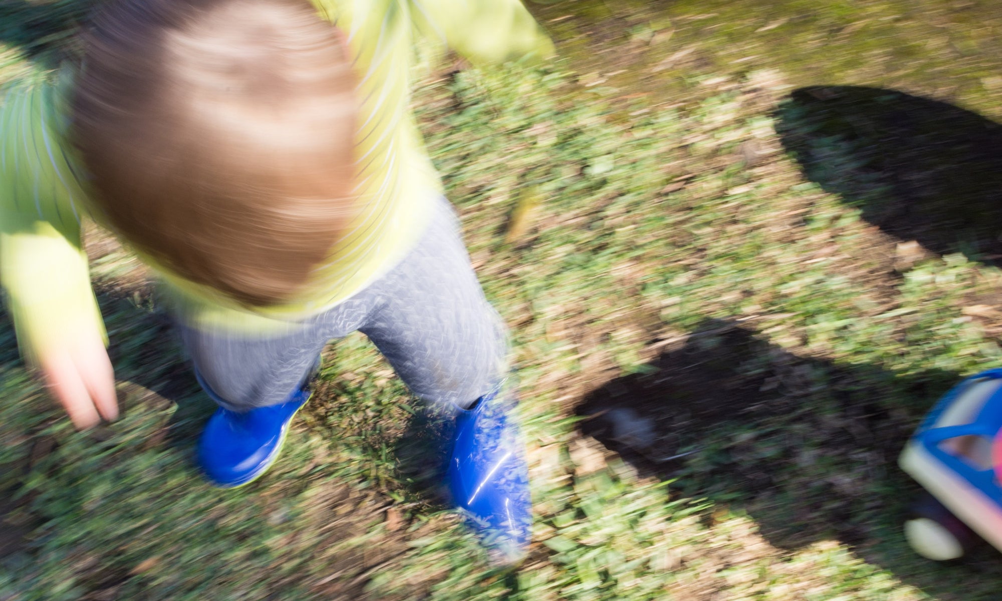 blur image of a kid playing in the garden