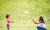 Mother And Daughter Playing In The Meadow