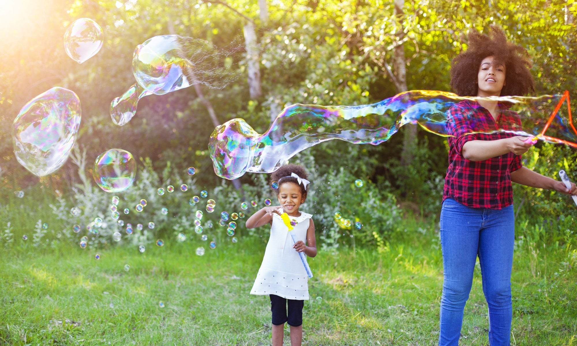 mother and daughter playing with bubbles