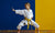 young girl practicing martial arts with a yellow belt