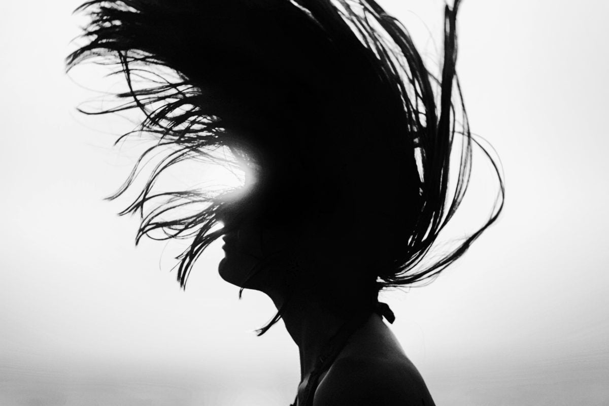 young lady tossing her long hair