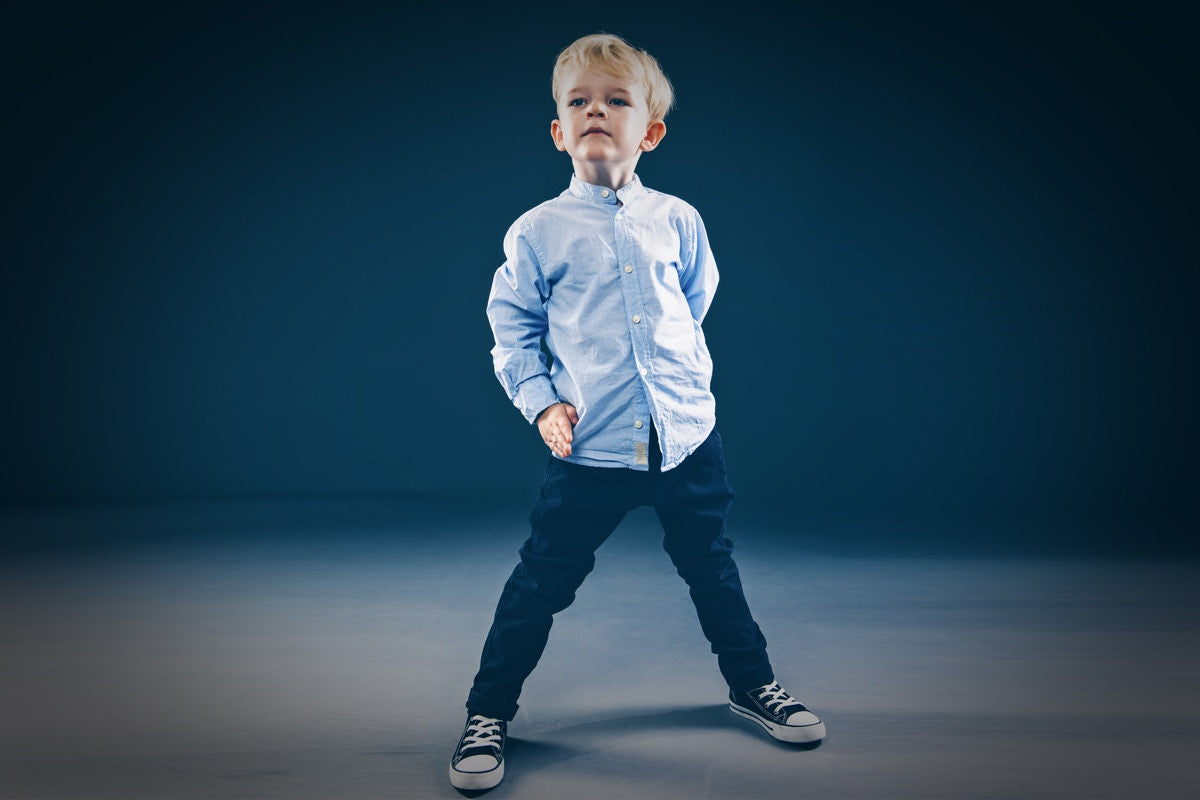 Young boy standing and posing for photoshoot