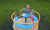 child spinning on playground roundabout