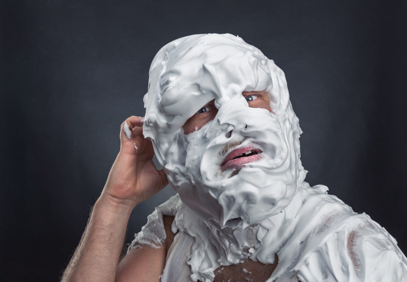 Crazy man with face completely in shaving foam