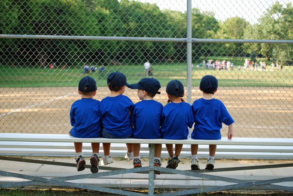 little boys sitting on bench in school ground