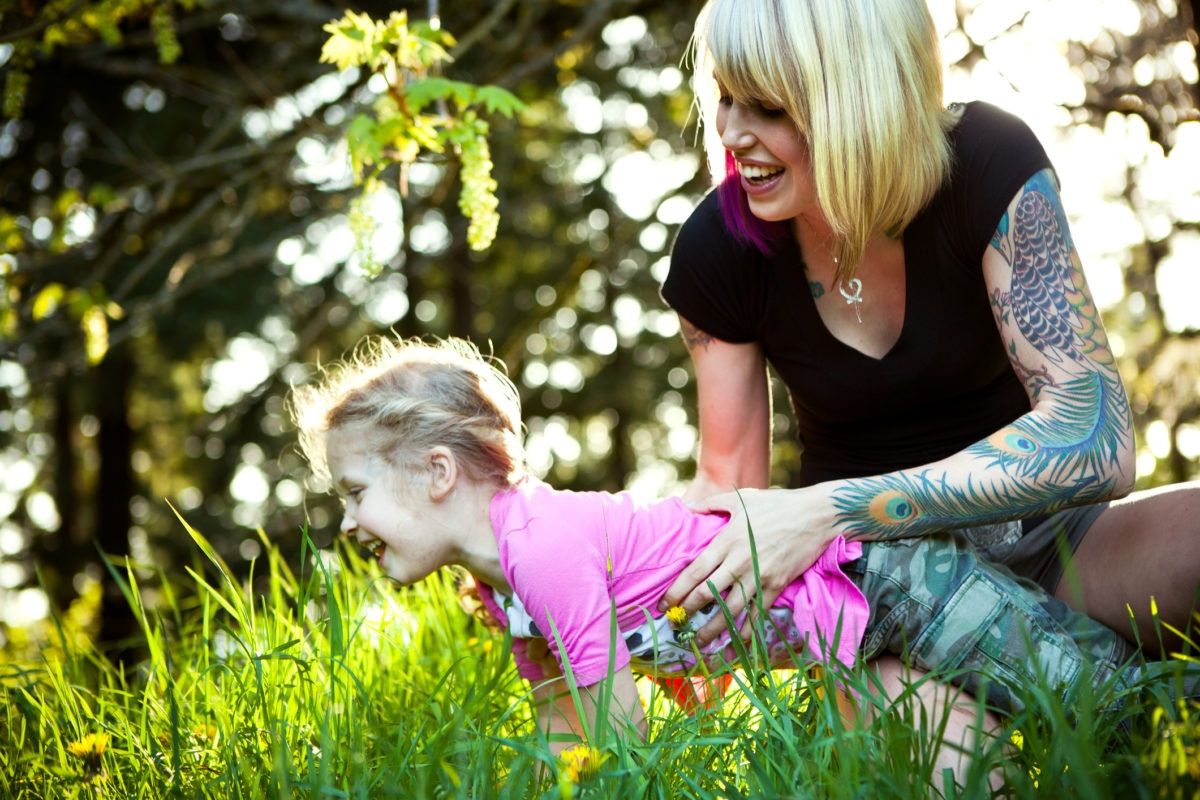 mother and daughter playing in filed