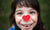 little girl looking up,heart shaped paper on her nose