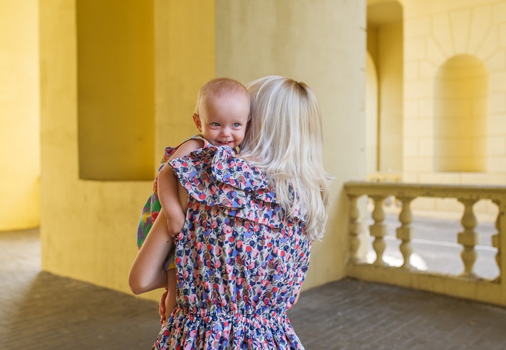 Mother holding a baby on shoulder