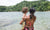 Mother and a child is standing near river side wearing bikini