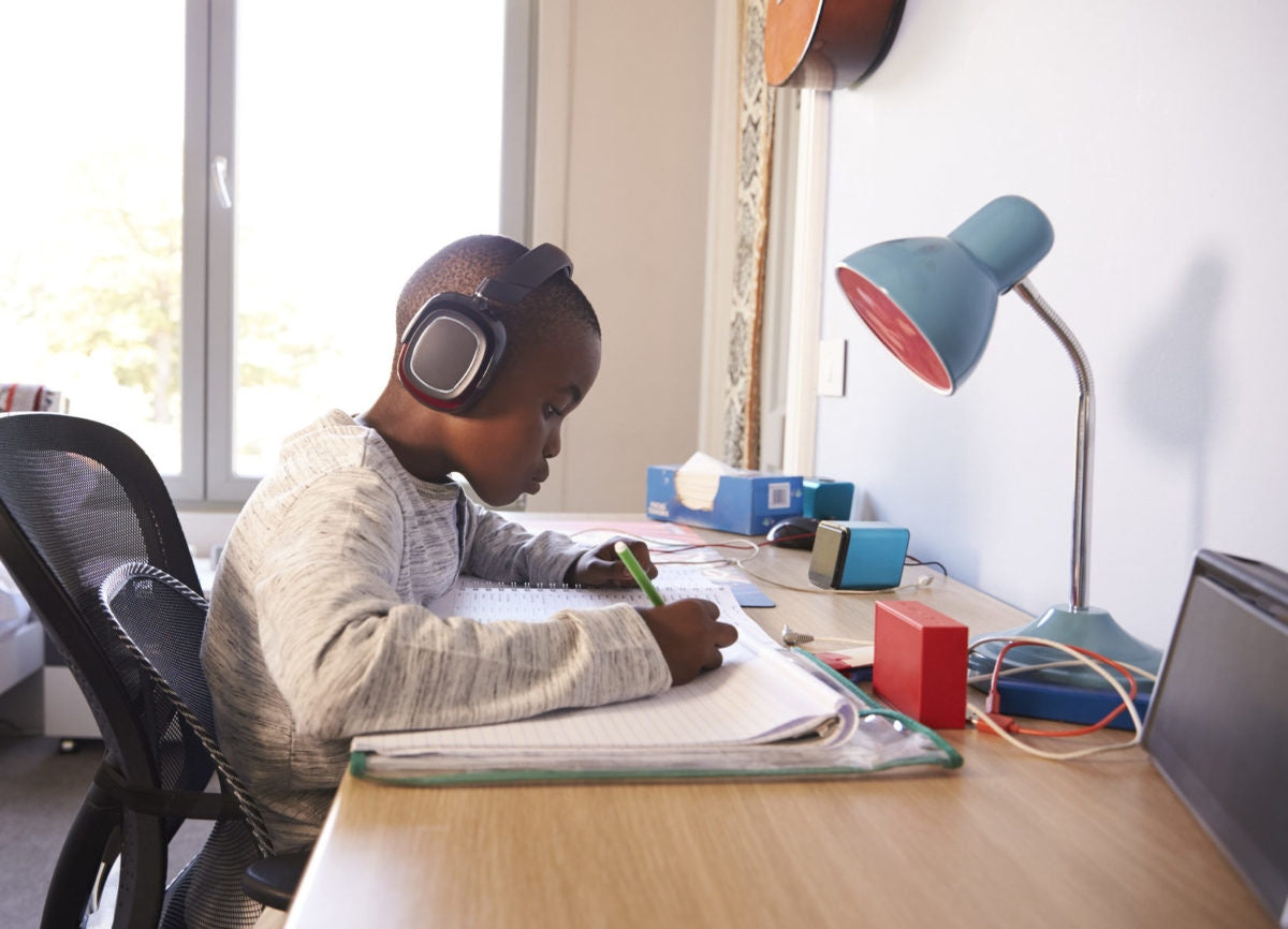 boy listening to music and writing