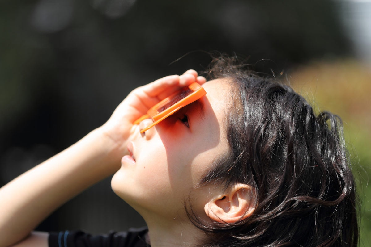 little girl safely viewing solar eclipse