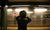 boy covering his ears at railway station