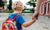 Mother holding hand of little daughter with backpack going to school