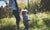 Boy holding a stick and walking with mother