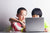 Two children using a laptop