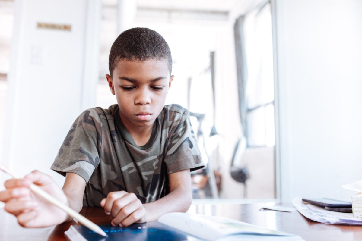 A child sitting in front of a table