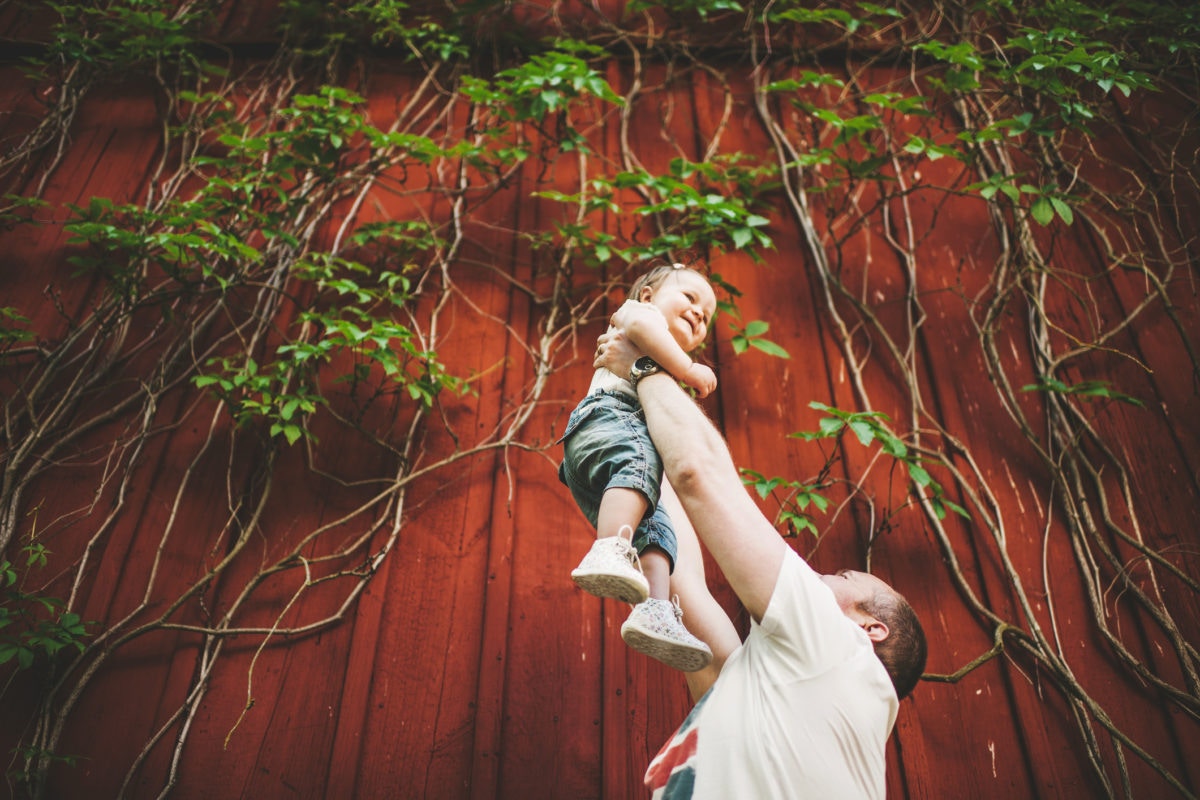 A father holding his baby up 