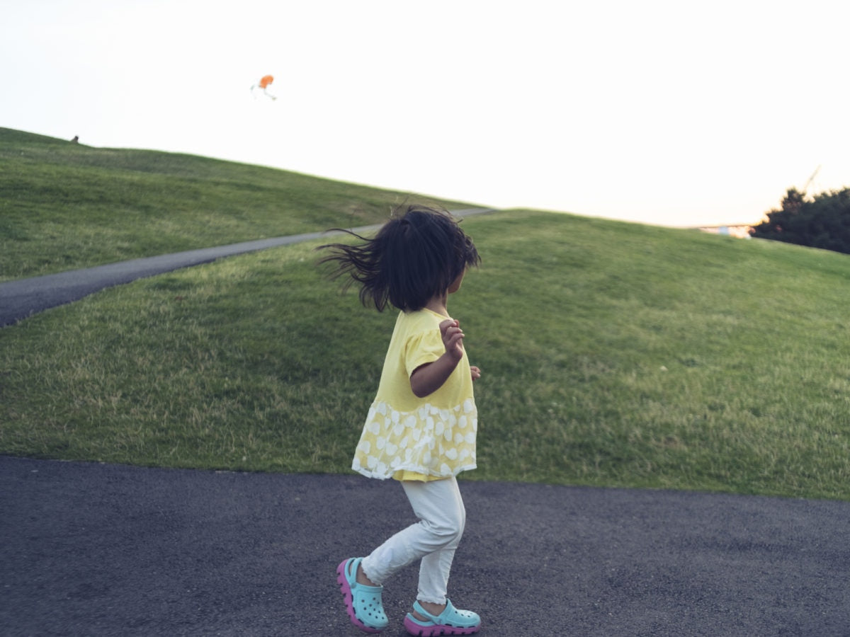 little girl walking in the mountain road