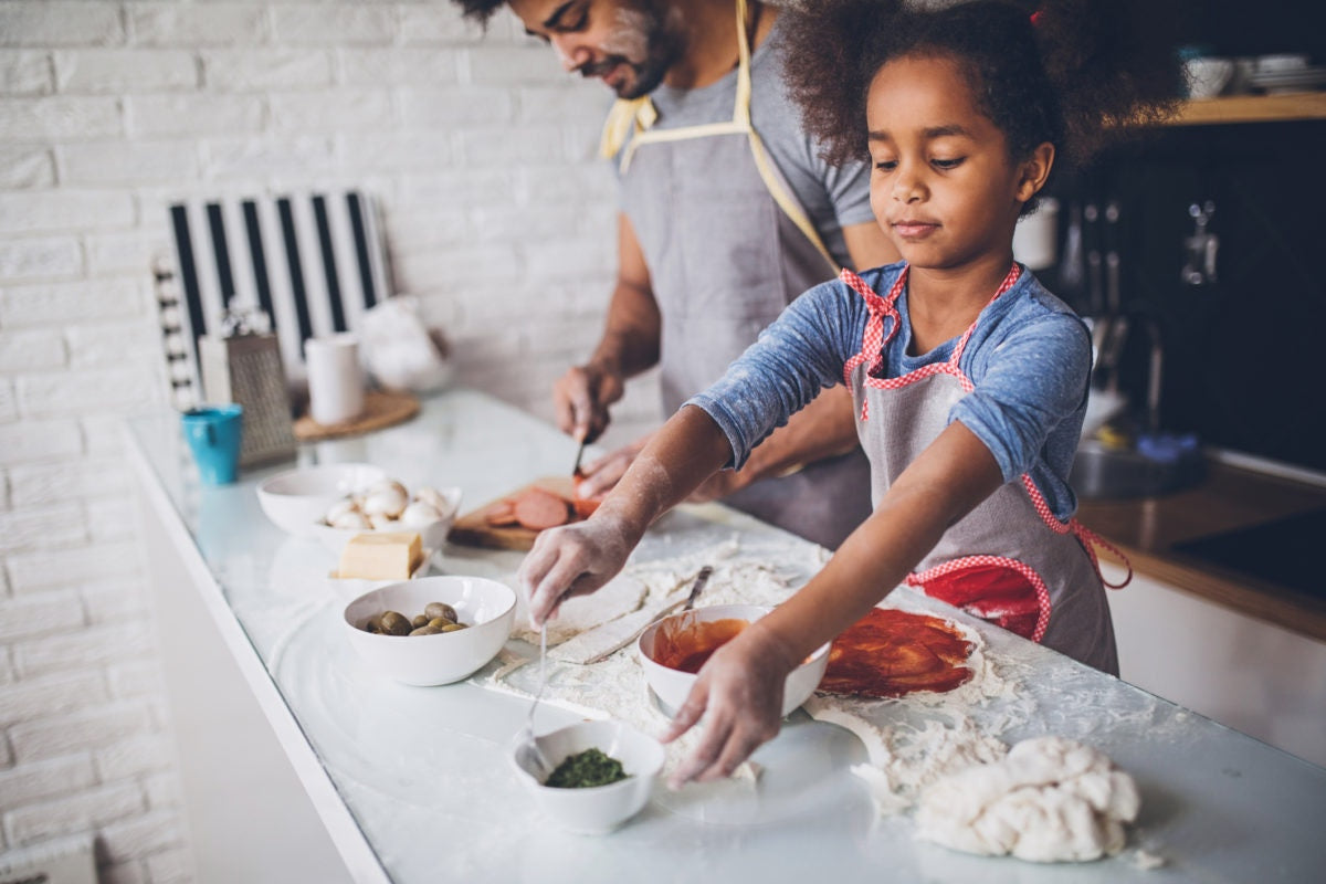 Children making something with flour on the kitchen