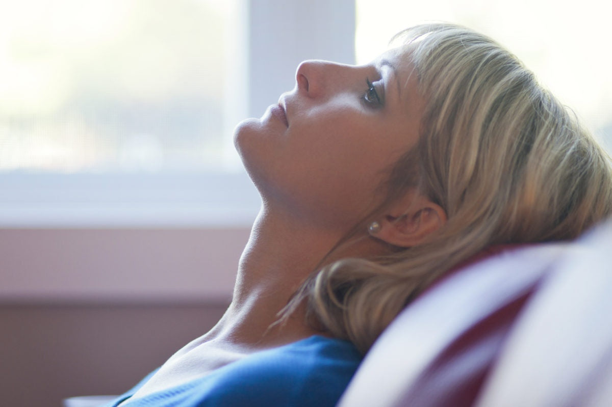 woman resting her head on sofa headrest