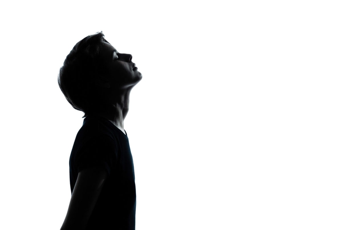 black and white image of boy looking up