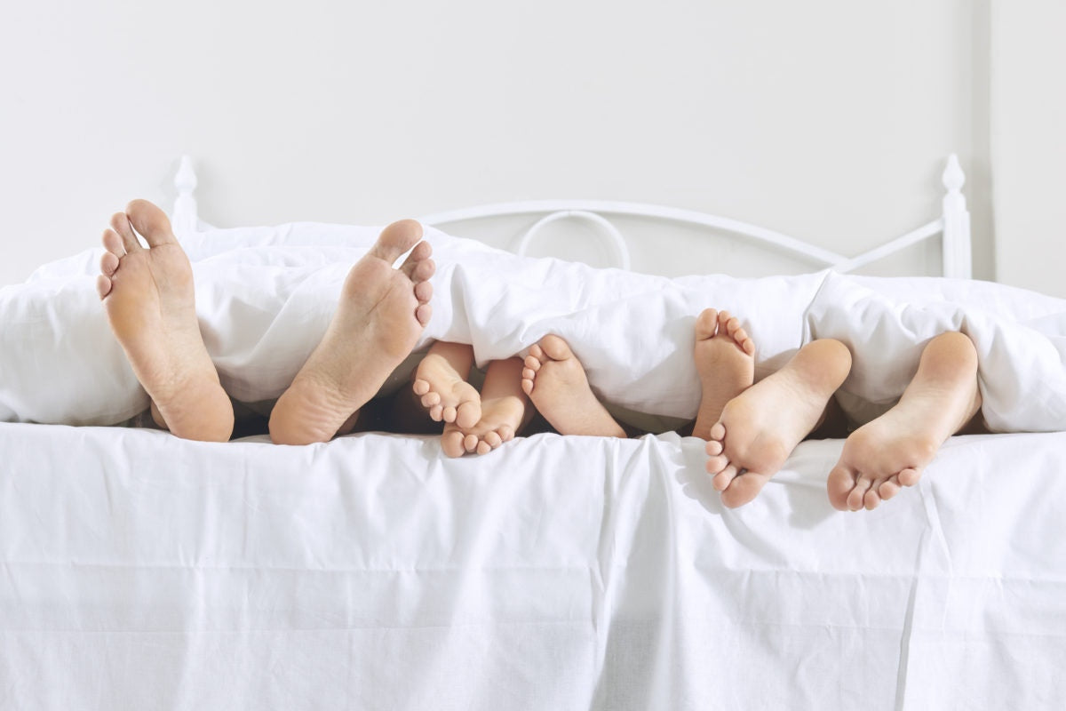 family's feet showing under covers