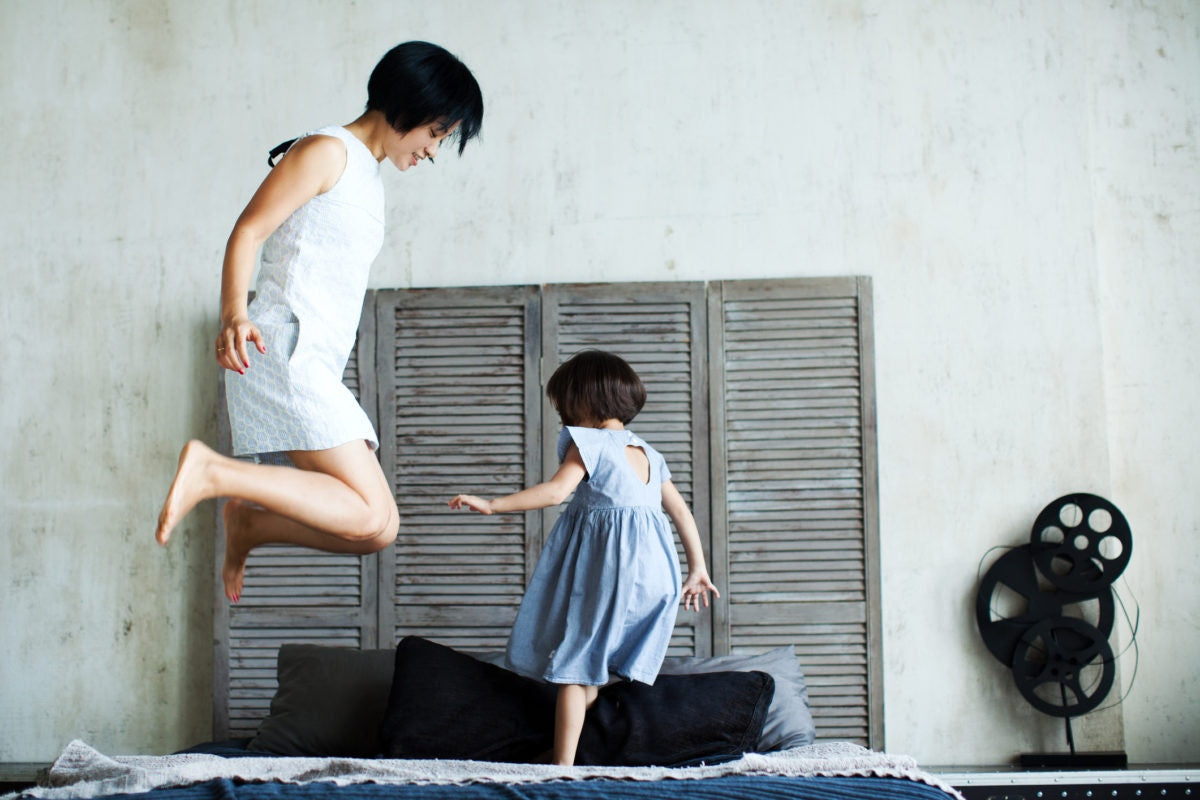 Mother and child playing in bedroom