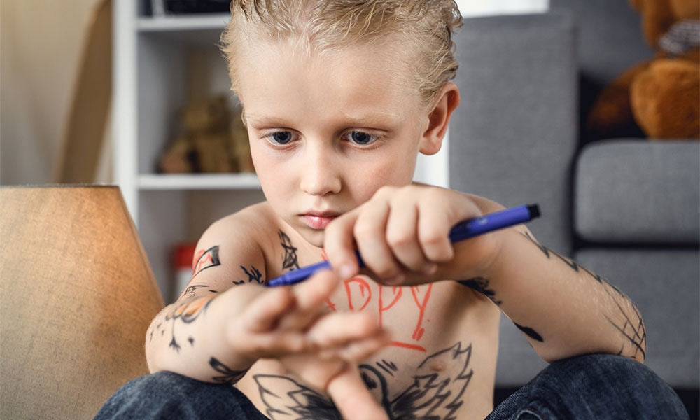 boy drawing on himself