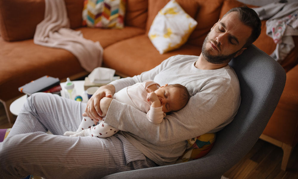 father sleeping with baby