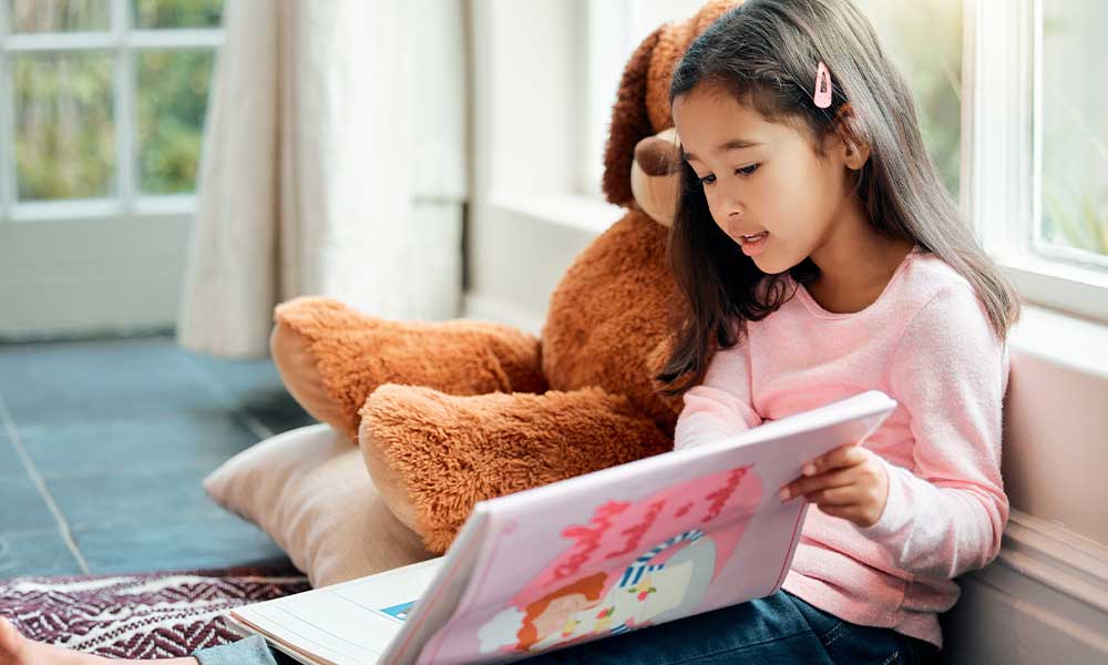 little girl reading a book