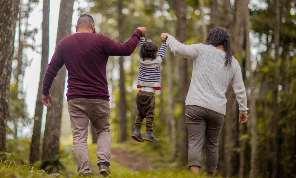 Man and Woman Carrying Toddler