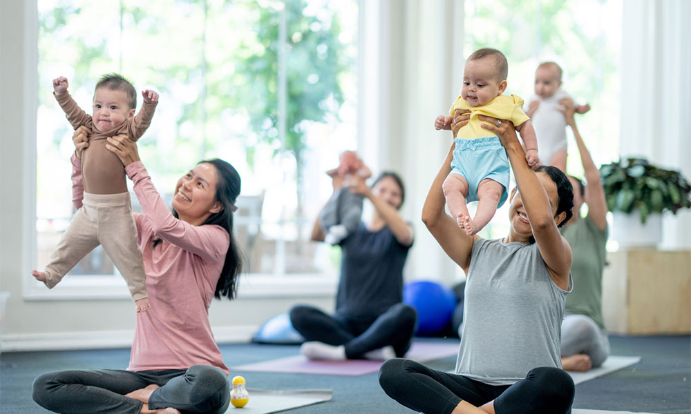 parents with baby in fitness class