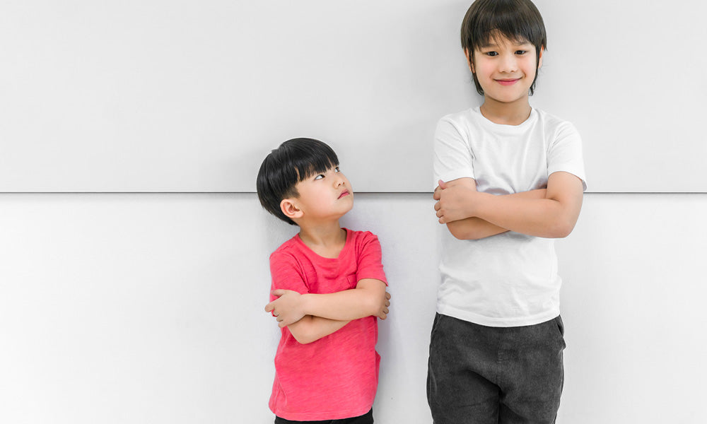 two boys standing arms crossed