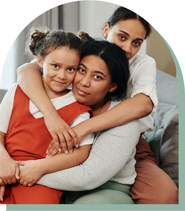 two children hugging their mother